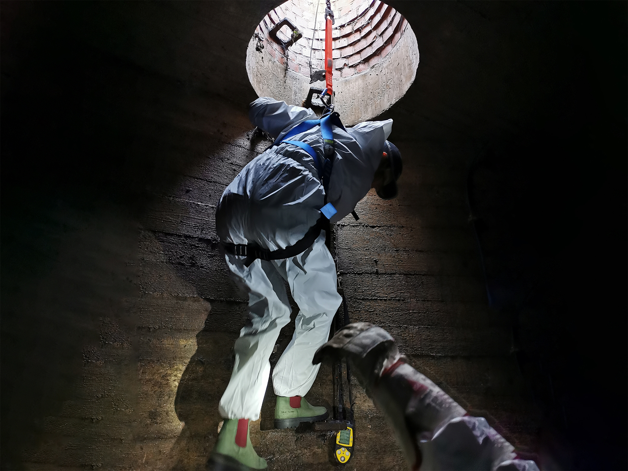picture taken in the storm sewer, scientist descending down the stairs